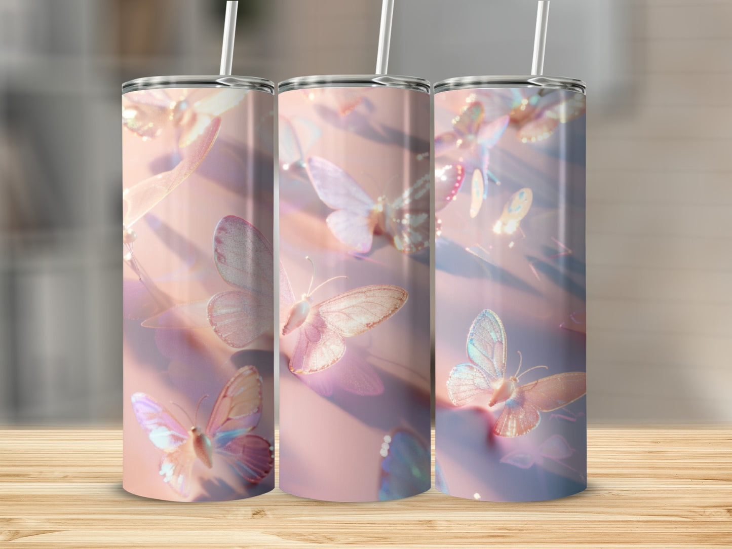 Three tumblers with iridescent butterfly pattern on a wooden surface.