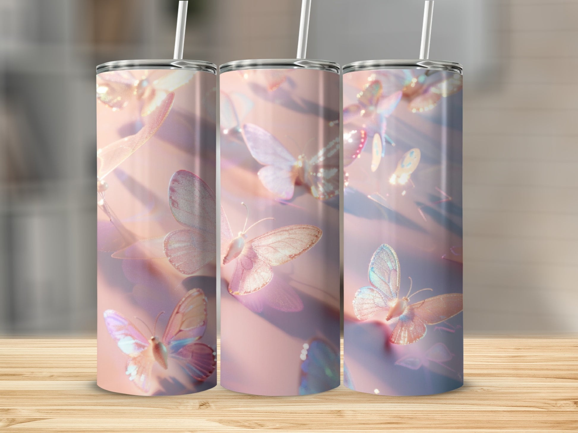 Three tumblers with iridescent butterfly pattern on a wooden surface.