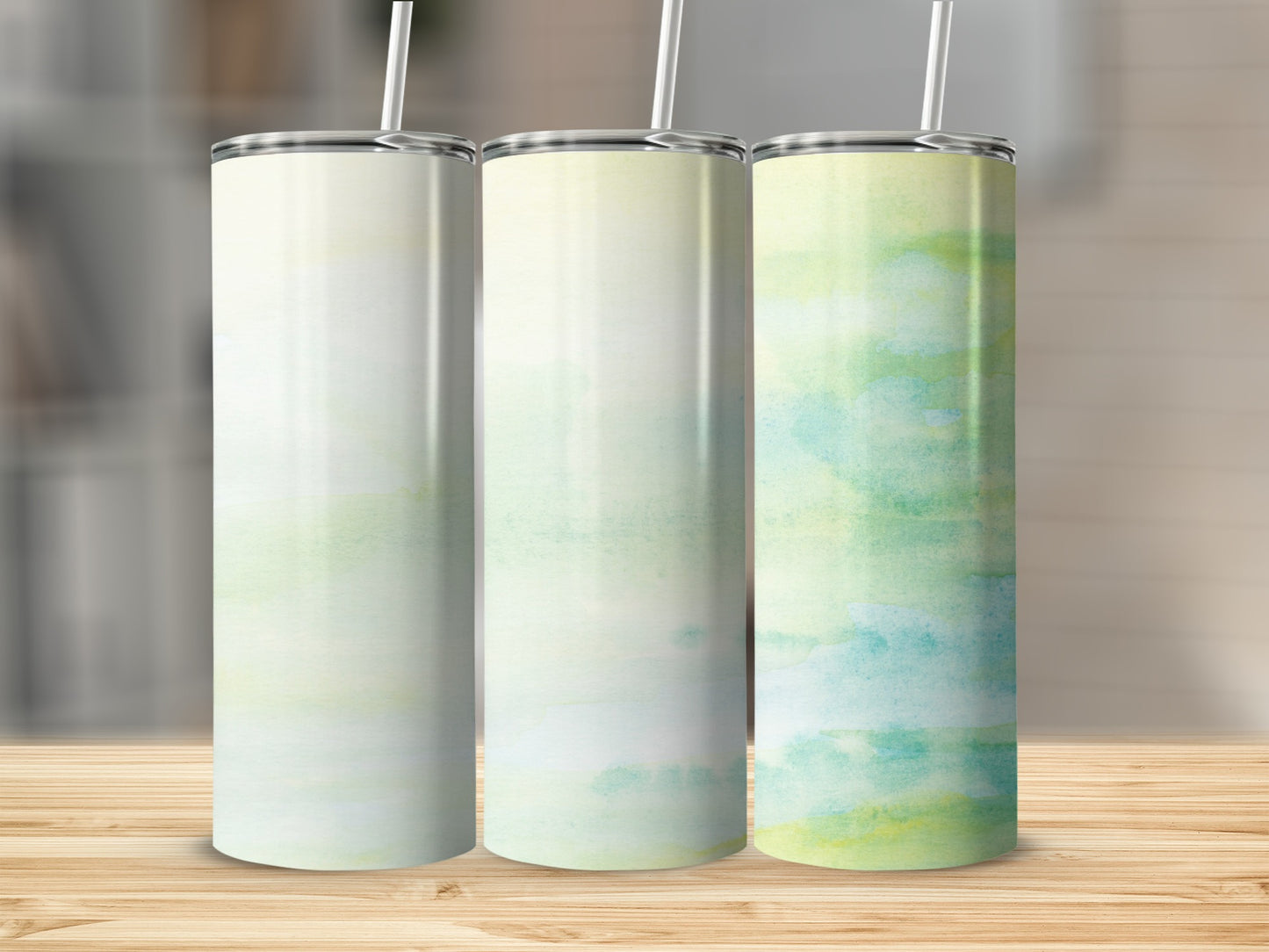 Three tumblers with abstract watercolor designs of green and yellow.