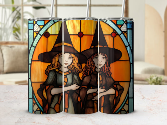 Two witches with orange and brown hats and robes on a stained glass background.