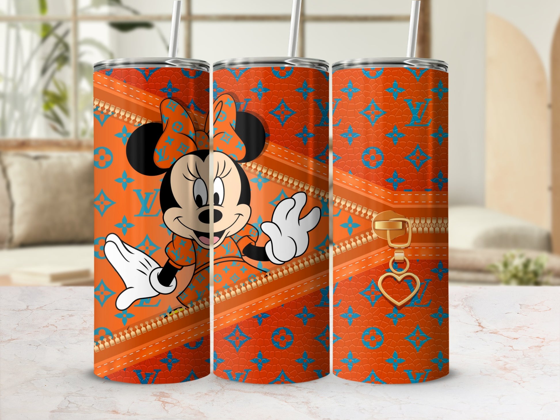 Minnie Mouse orange tumbler with blue monogram and gold zipper detail.
