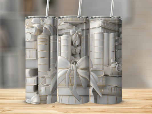 Three tumblers featuring stacks of white books tied with gold bows.
