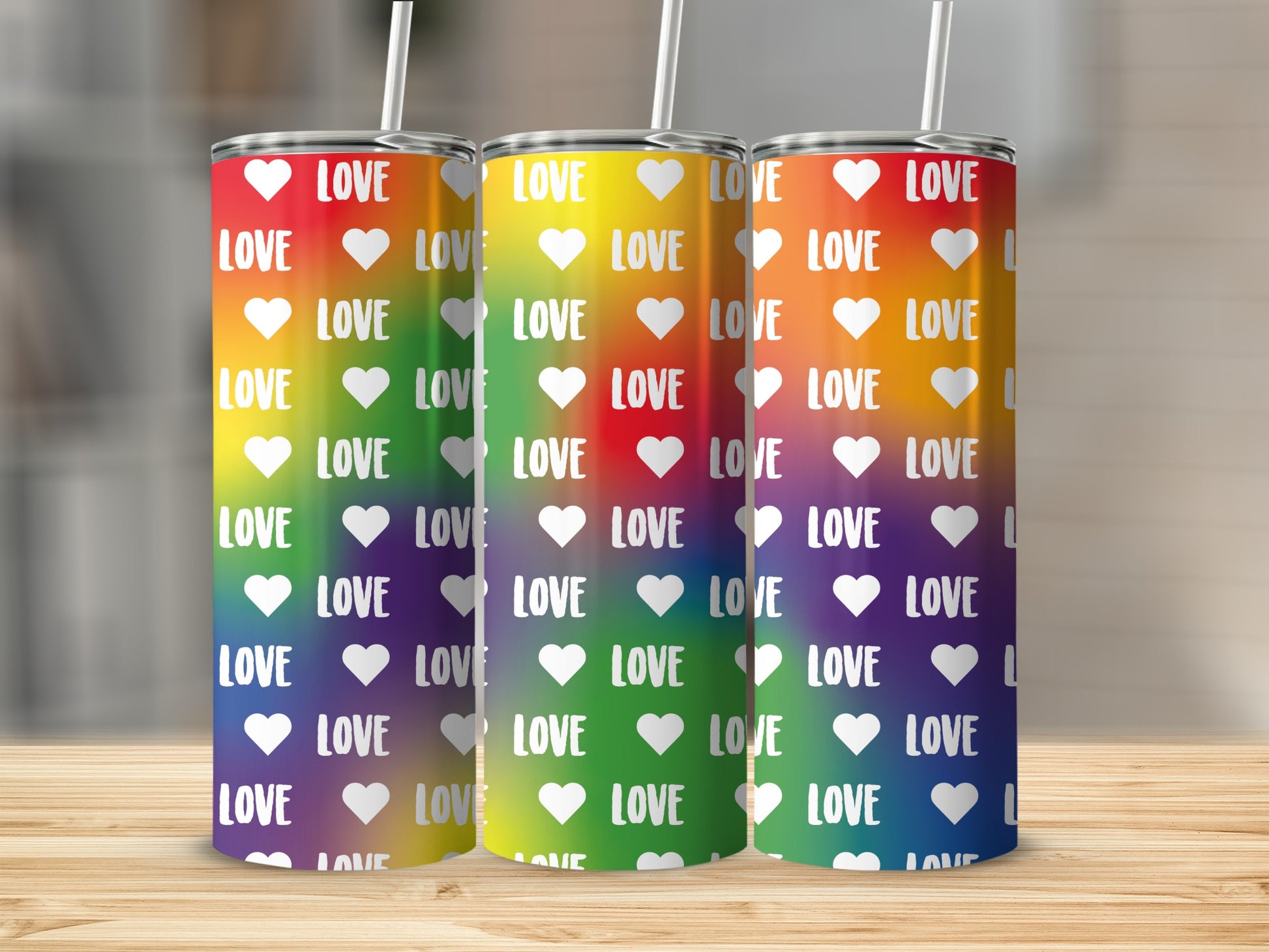 Rainbow gradient tumbler with repeating "LOVE" and heart pattern.