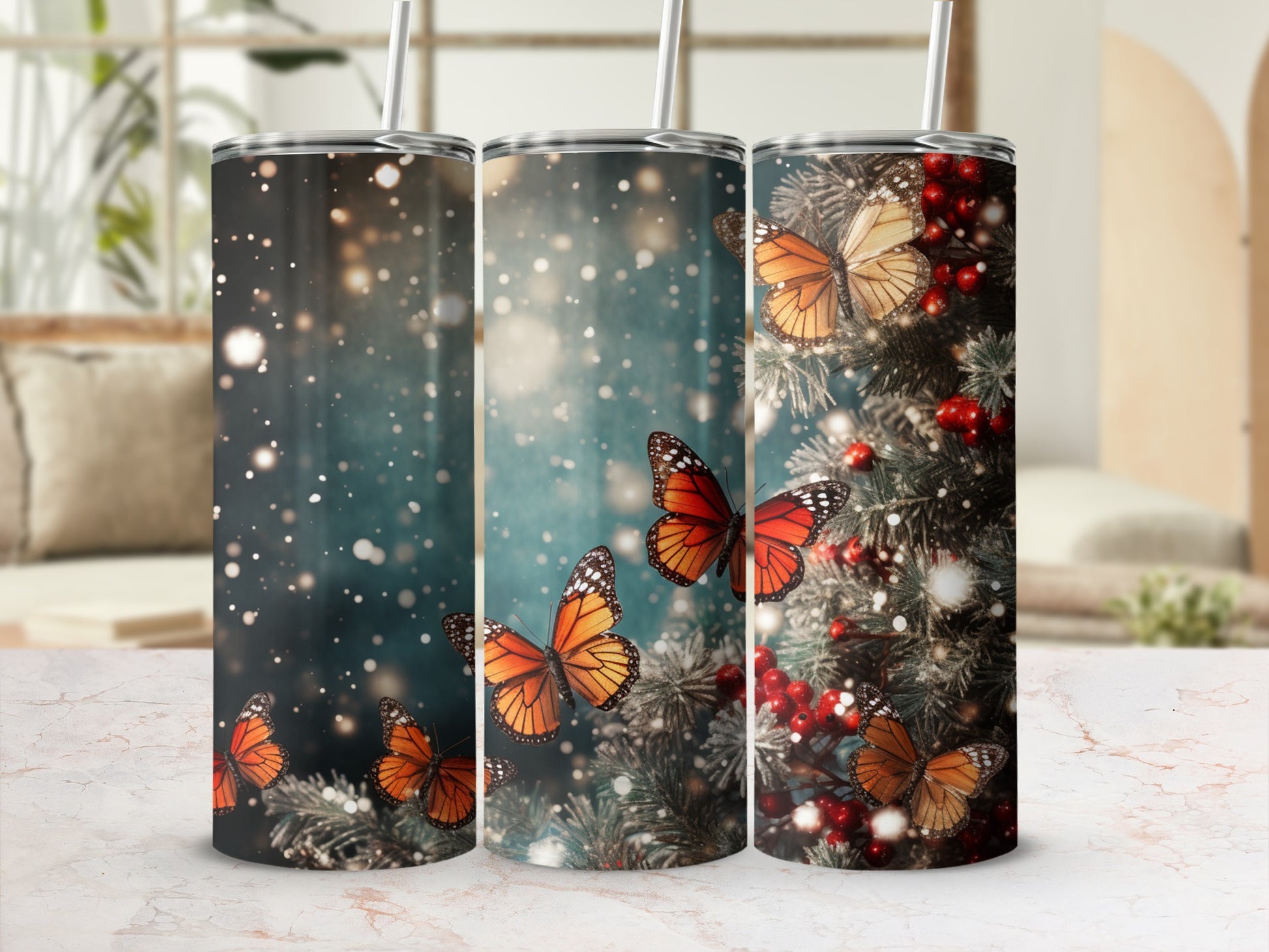 Three tumblers with monarch butterflies and festive greenery.