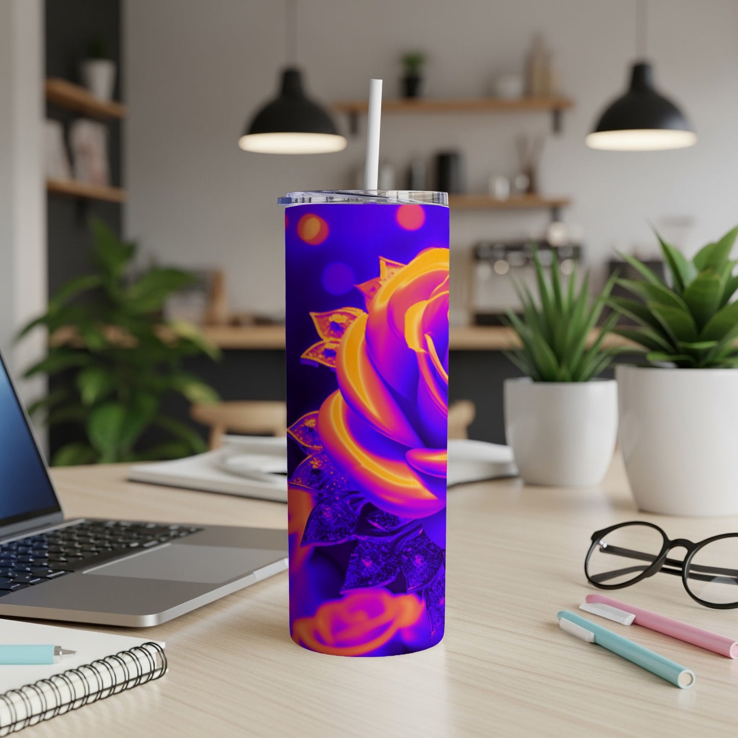 Vibrant abstract rose design on a blue background, on a white tumbler with a straw.