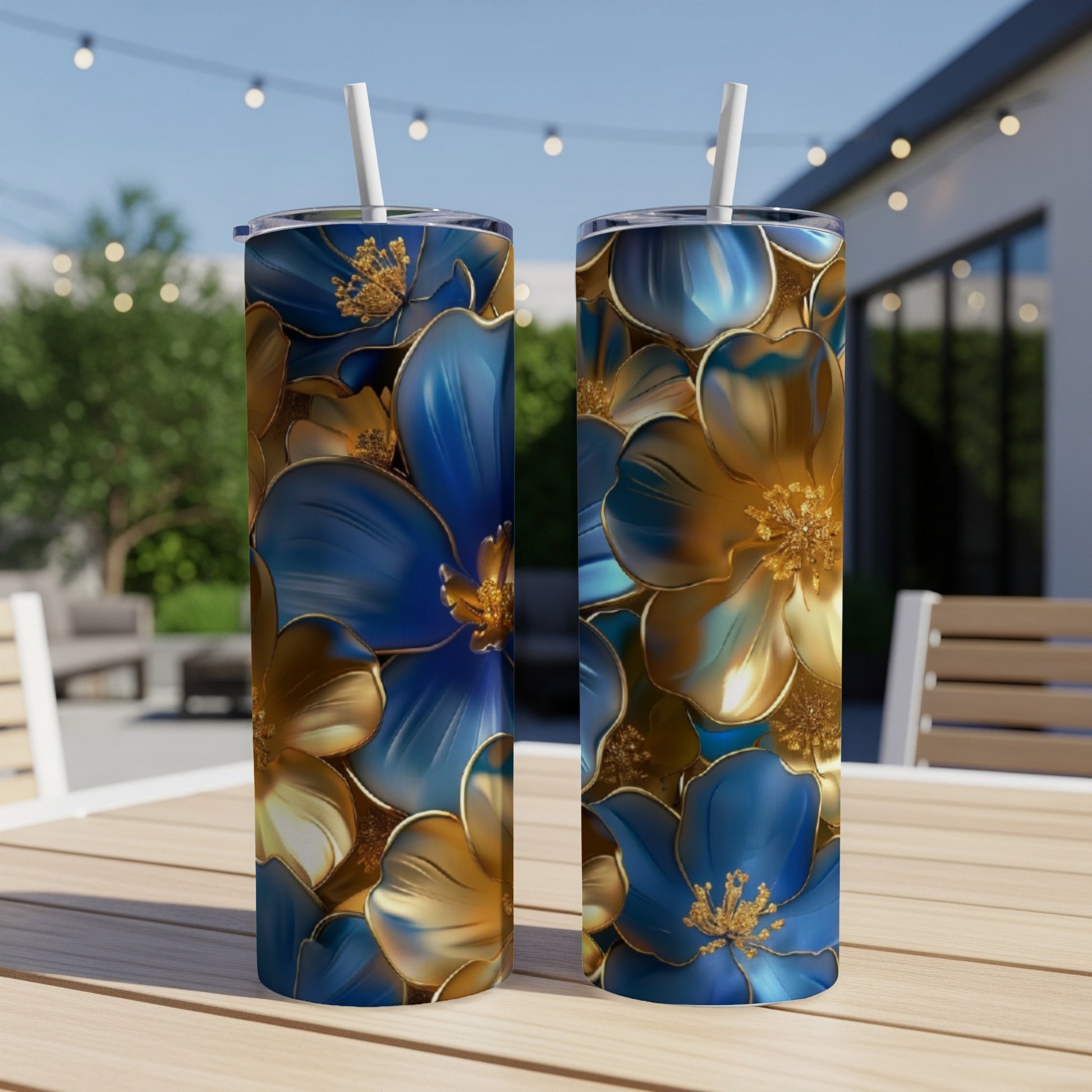 Two blue and gold floral pattern tumblers on a wooden table.