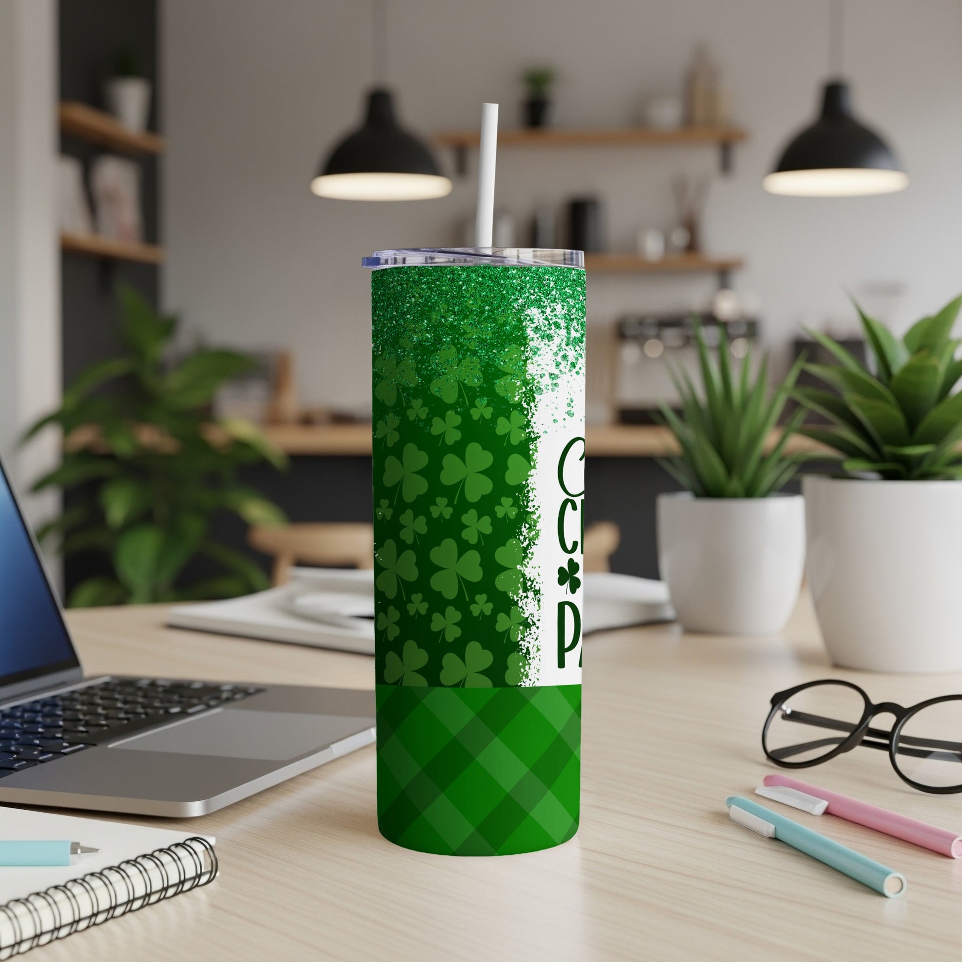 Green tumbler with shamrocks and "Coffee" text on a desk.