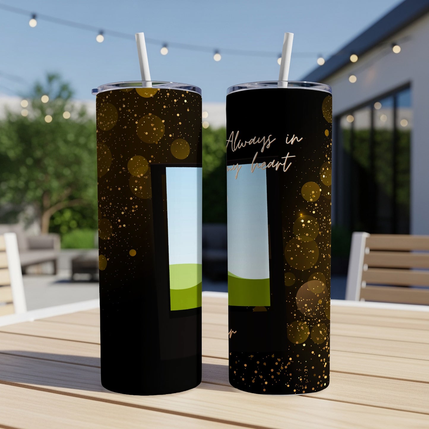 Two black tumblers with gold bokeh, featuring a landscape scene and text "Always in my heart."
