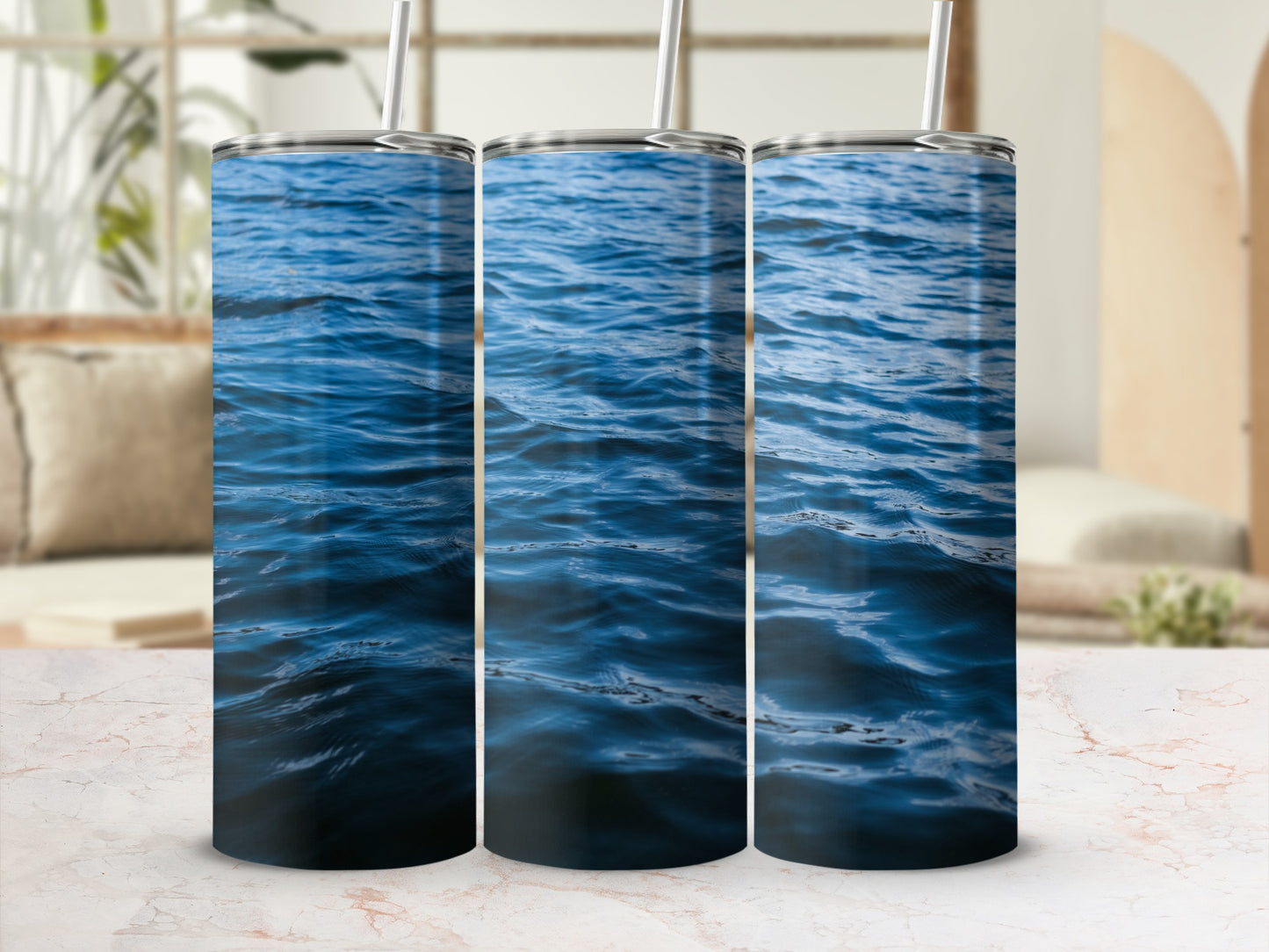 Three tumblers displaying a close-up of deep blue rippling water.