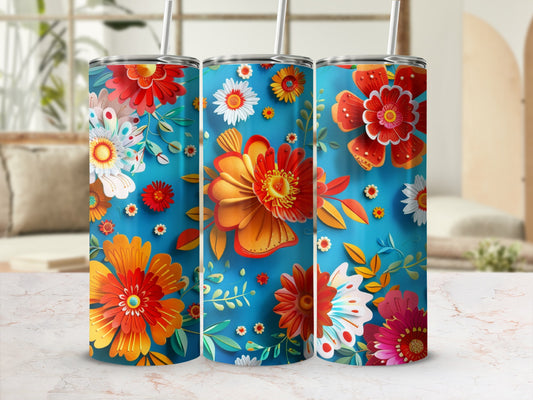 Three tall tumblers with vibrant floral designs and straws.