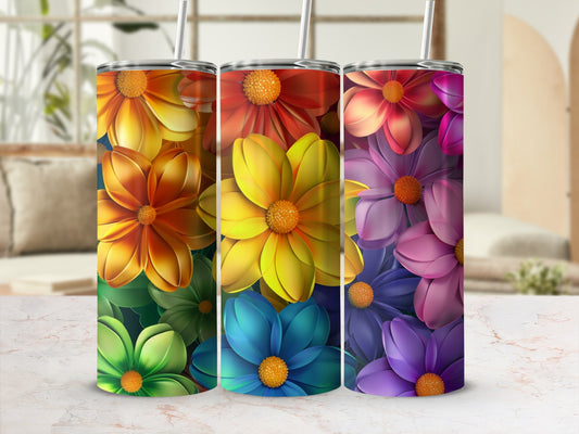Colorful floral pattern tumbler with straw, against a blurred background.