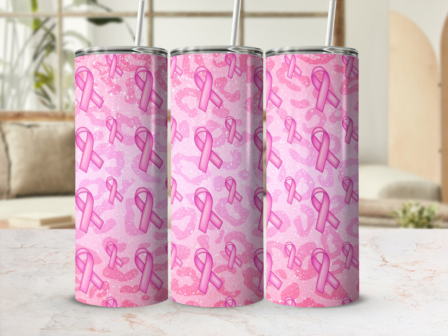Pink breast cancer ribbon pattern on three tumblers with straws.