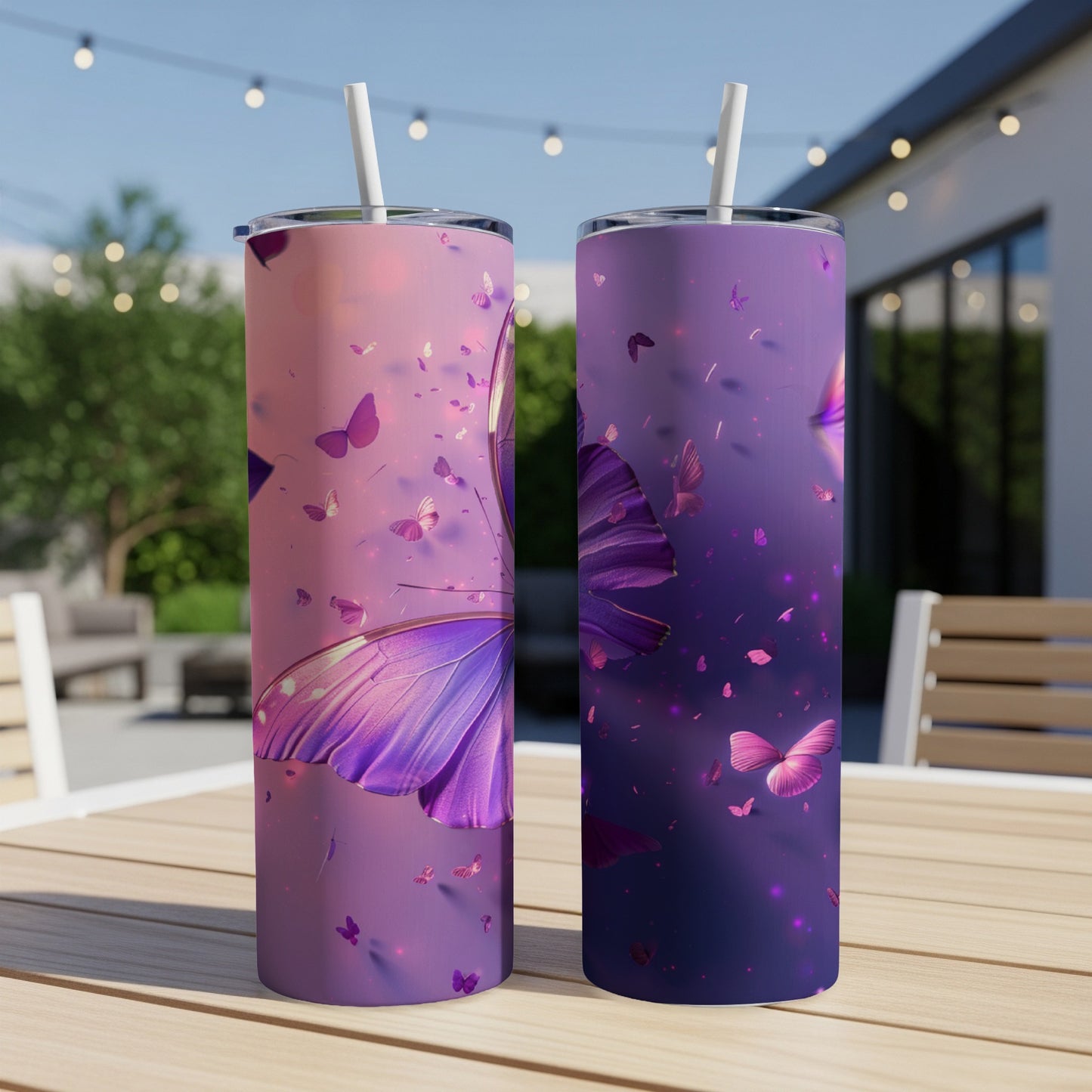 Two purple butterfly tumblers with lids and straws on a table.