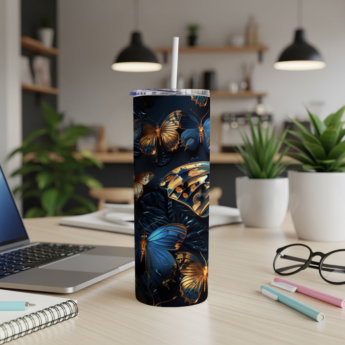 Tumbler with dark background and detailed blue and gold butterflies.
