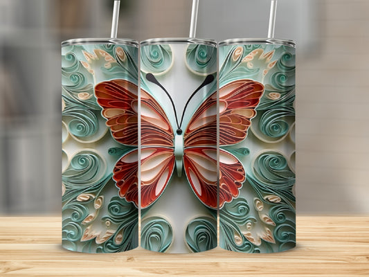 Three tumblers featuring a decorative butterfly design on a wooden surface.