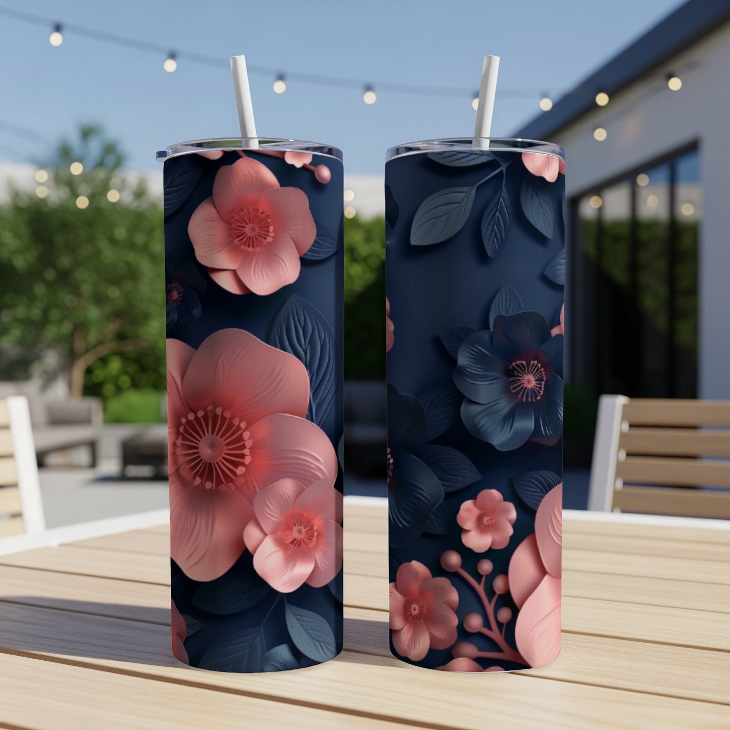 Two dark blue tumblers with a floral pattern of pink and dark blue flowers.