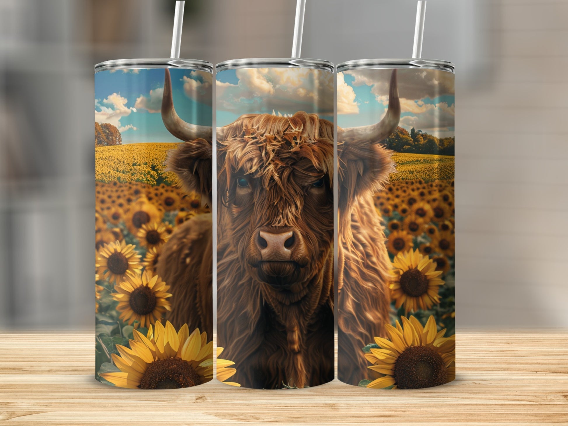 Highland cow in sunflower field, artwork on three tumblers.