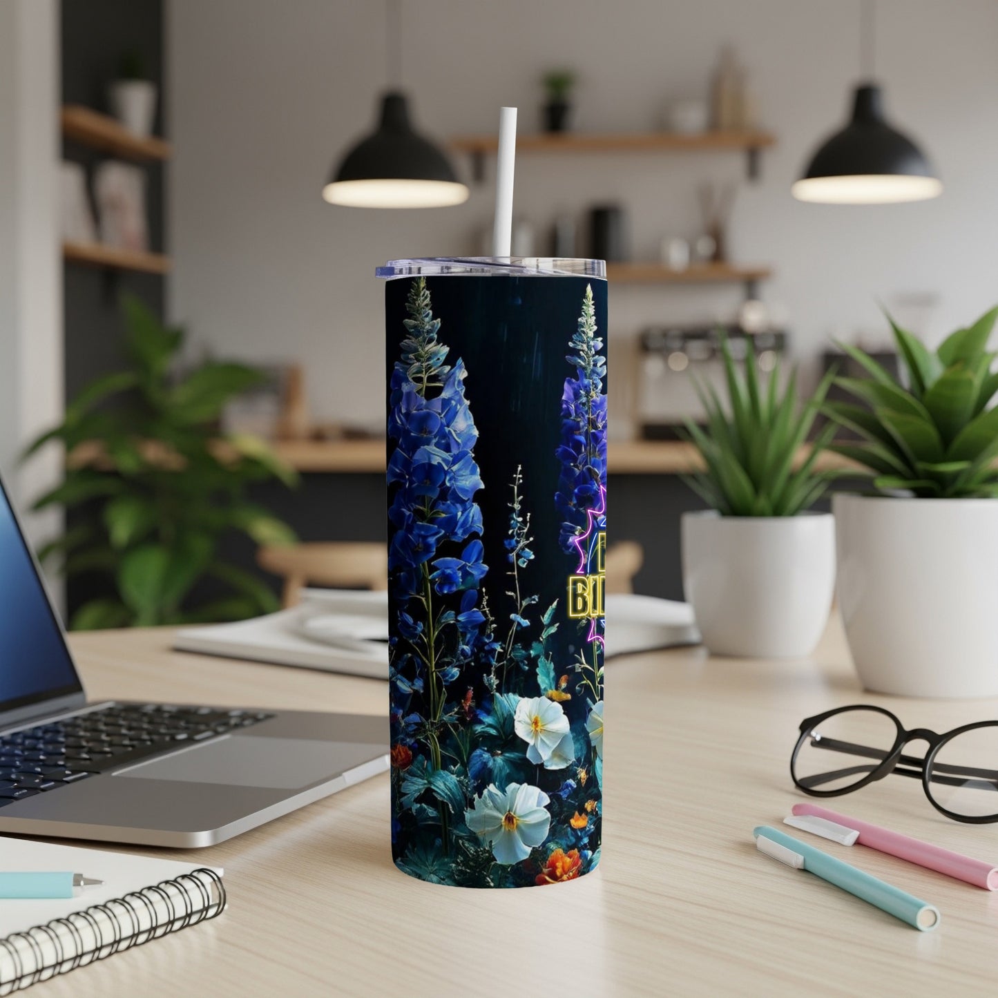 Tall dark tumbler with blue flowers, white flowers, and text.