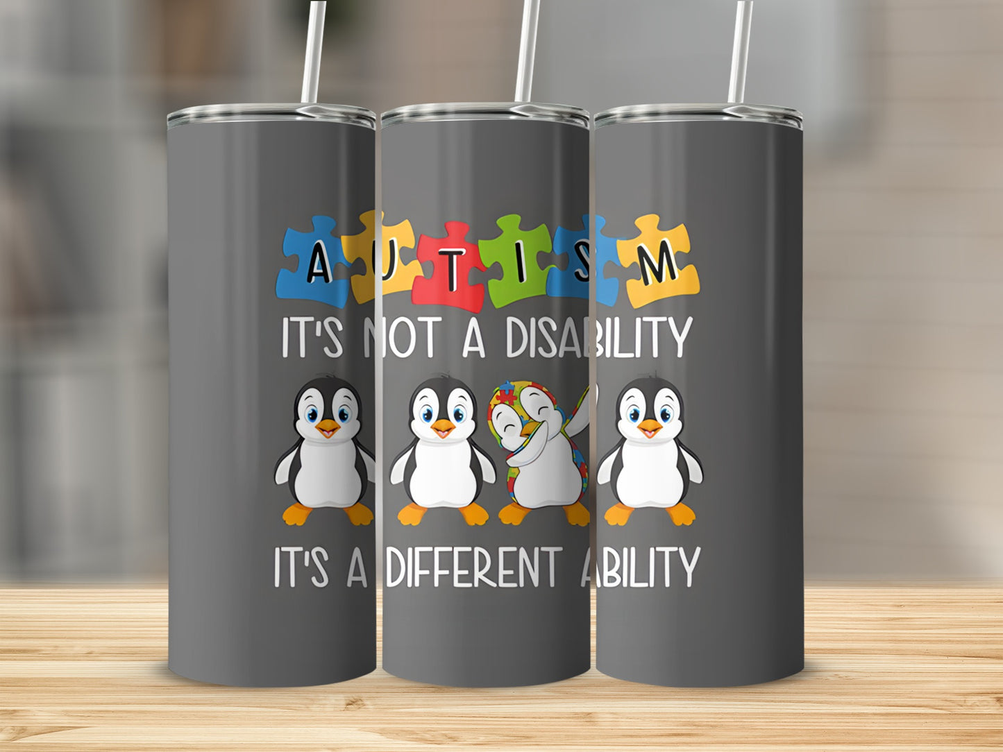 Autism awareness tumbler with penguins and puzzle pieces.