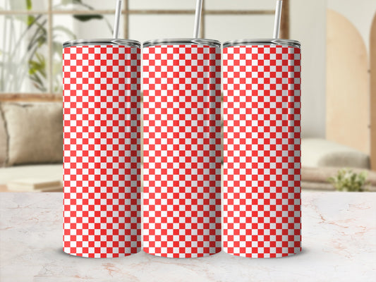 Three red and white checkered tumblers with straws on a marble surface.