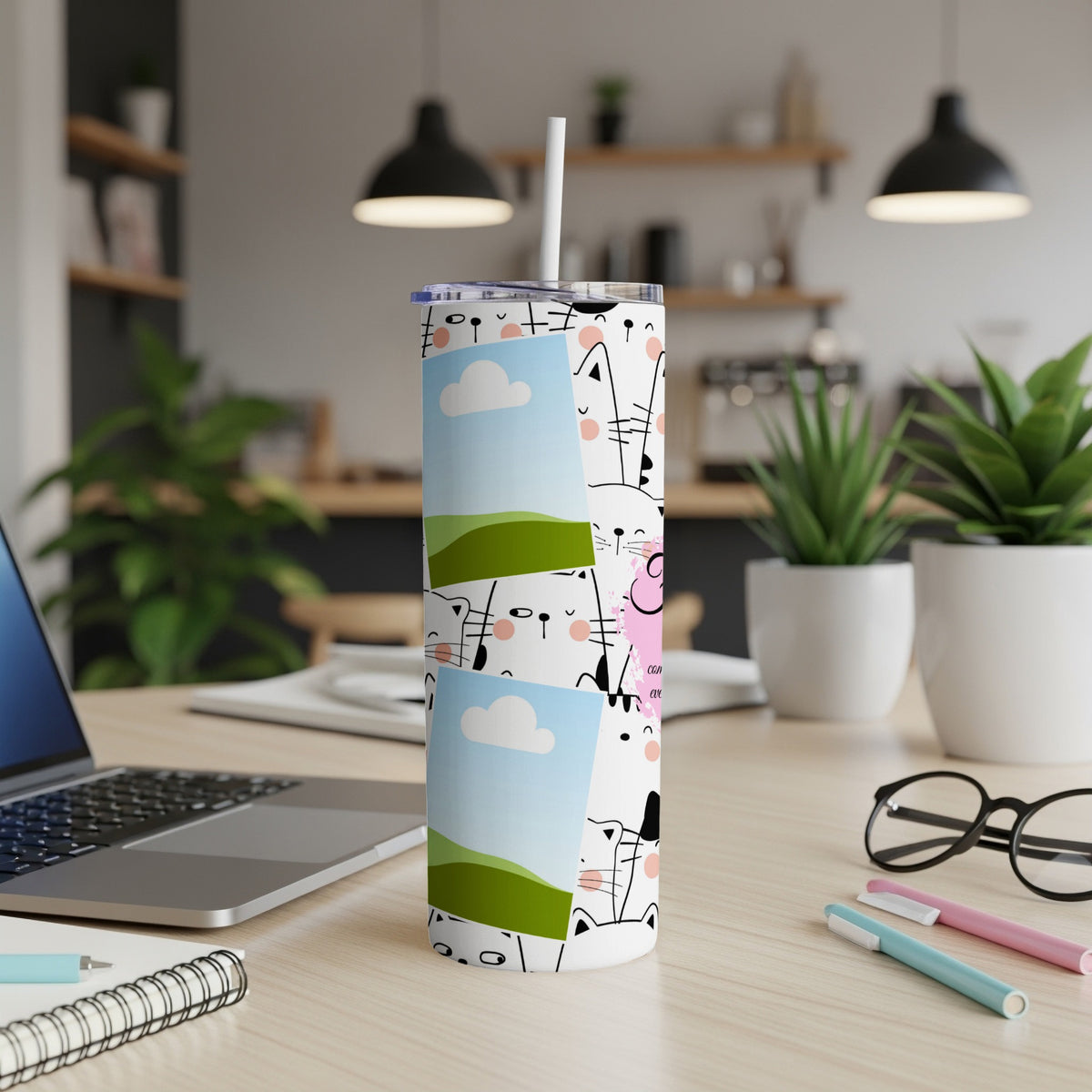 Tumbler with a pattern of cartoon cats and embedded photo frames on a desk.
