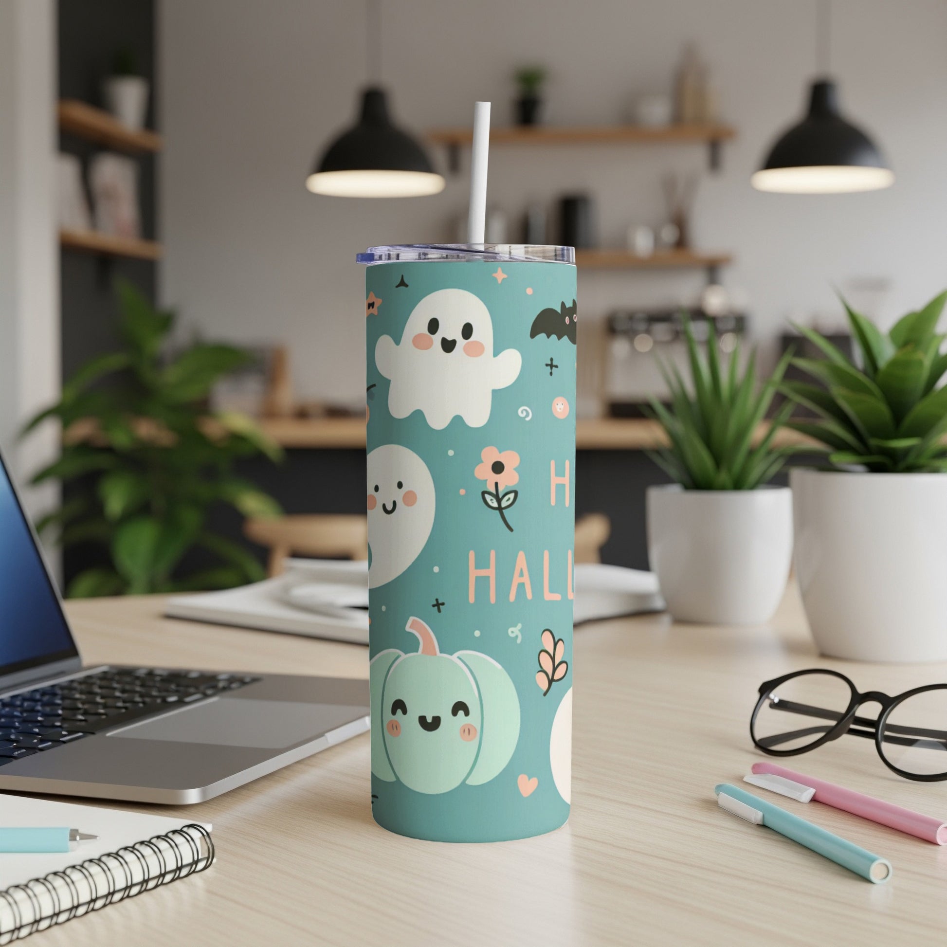 Teal tumbler with Halloween ghosts, bats, pumpkins, and text "Happy Halloween".