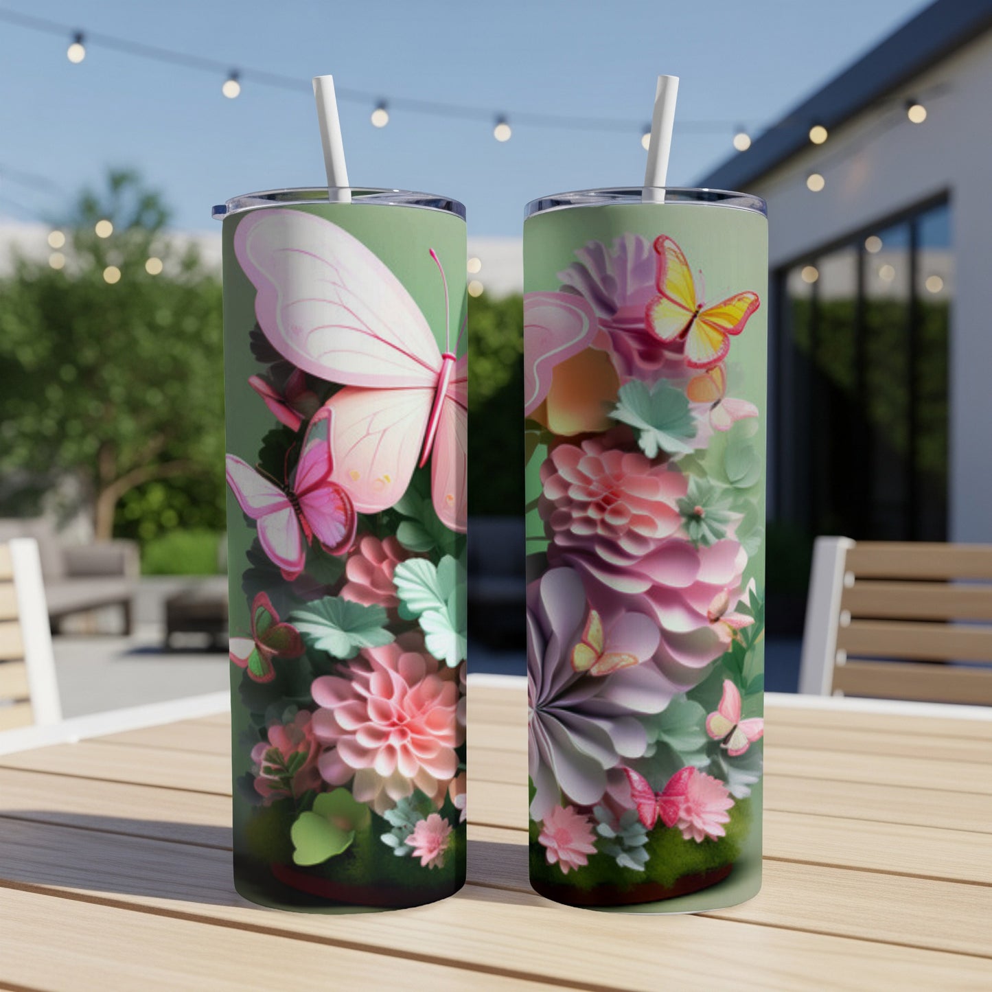 Two tall tumblers with a pastel butterfly and floral design on a wooden table.