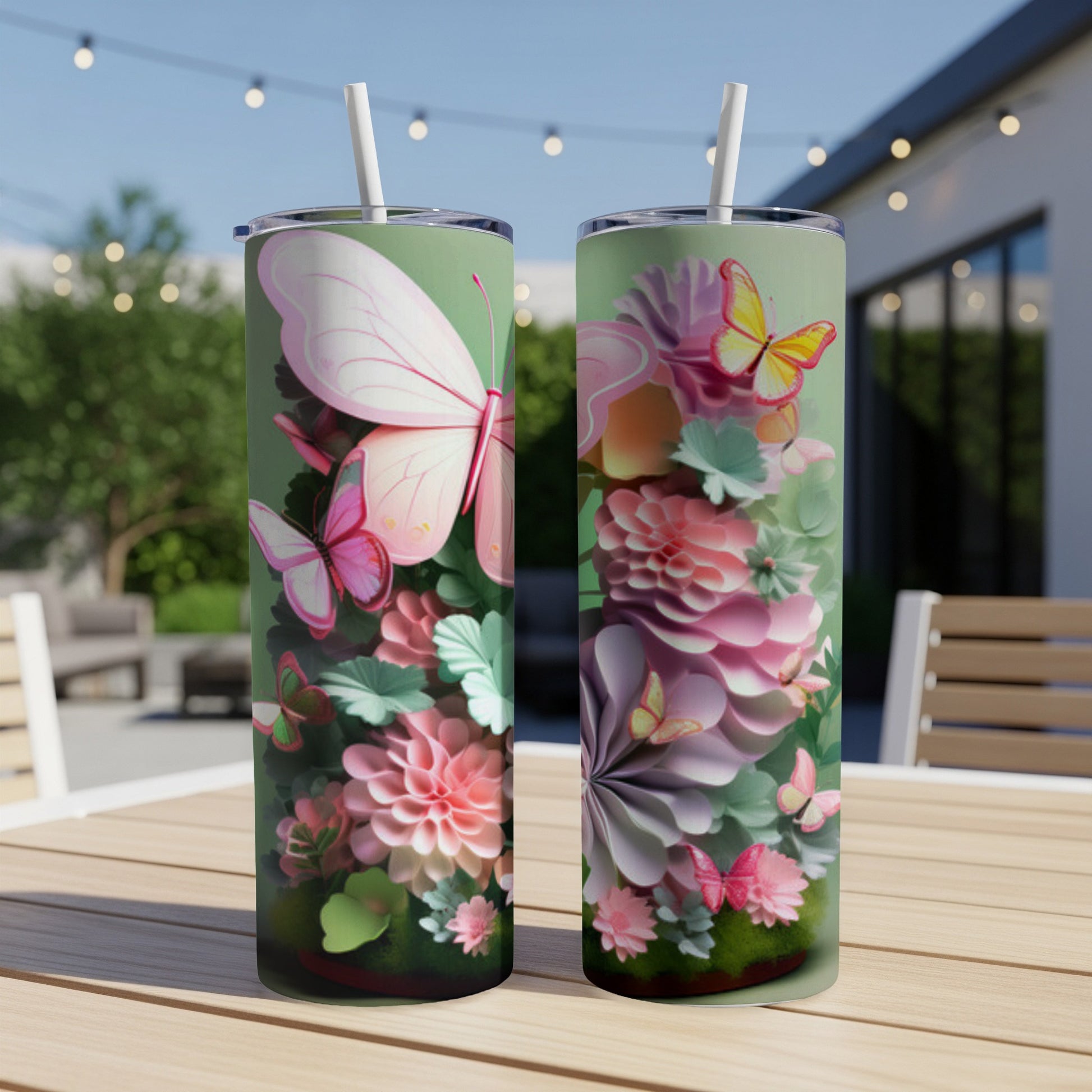 Two tall tumblers with a pastel butterfly and floral design on a wooden table.