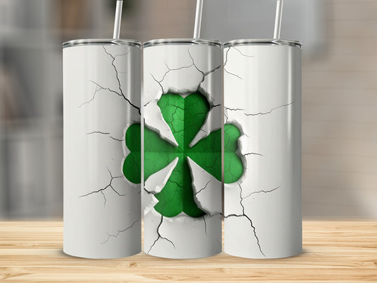 Cracked white tumbler with a green shamrock design.