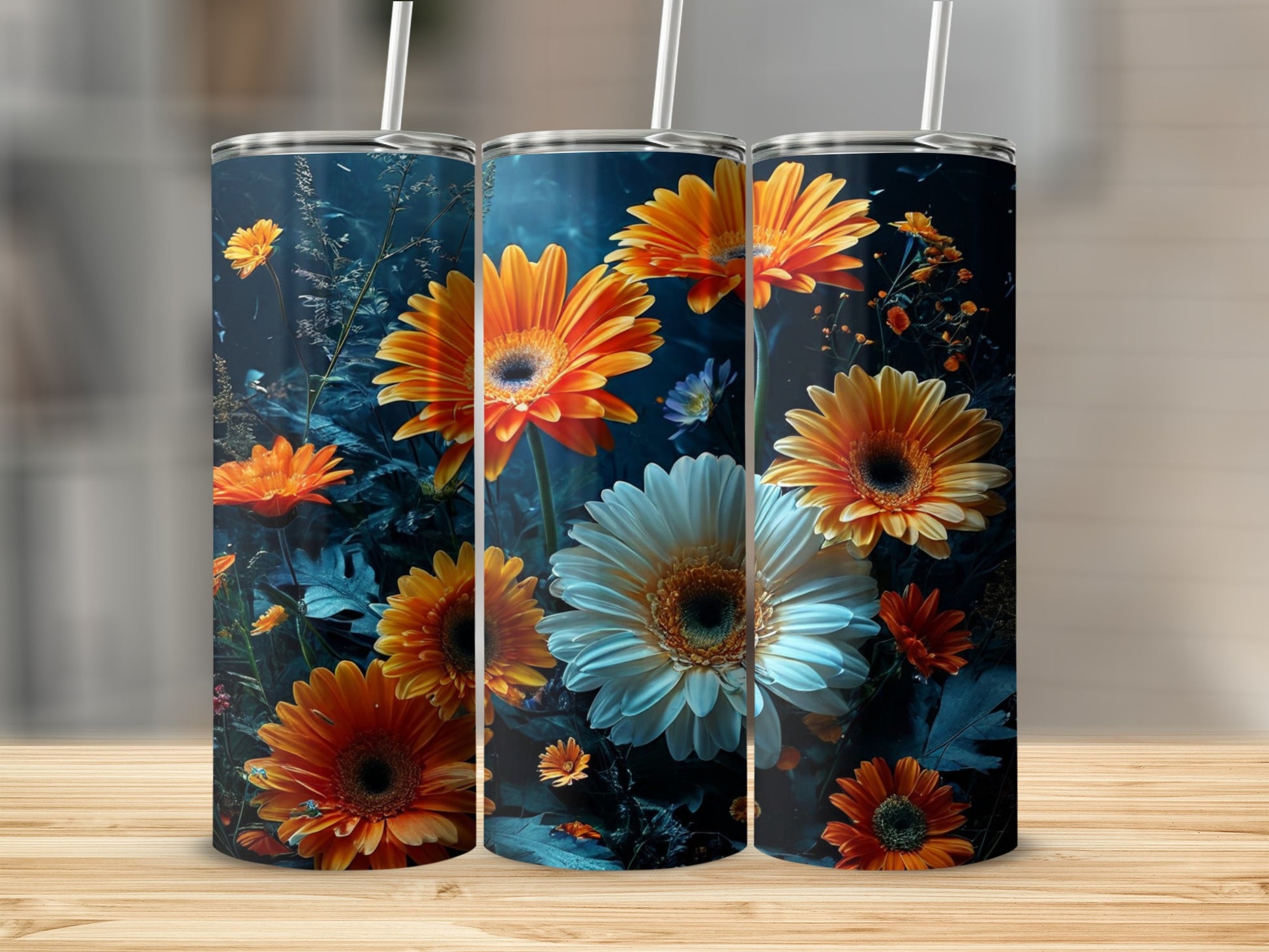 Three tumblers with floral designs featuring orange and white gerbera daisies.
