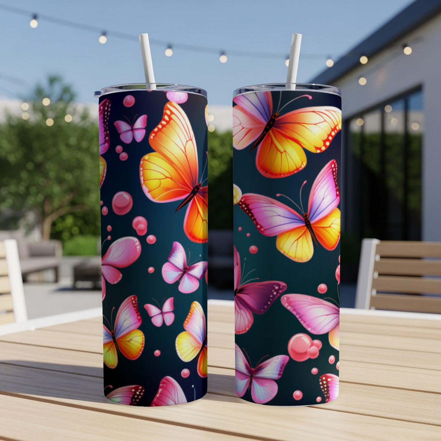 Two tumblers with colorful butterflies and pink bubbles on a dark background.