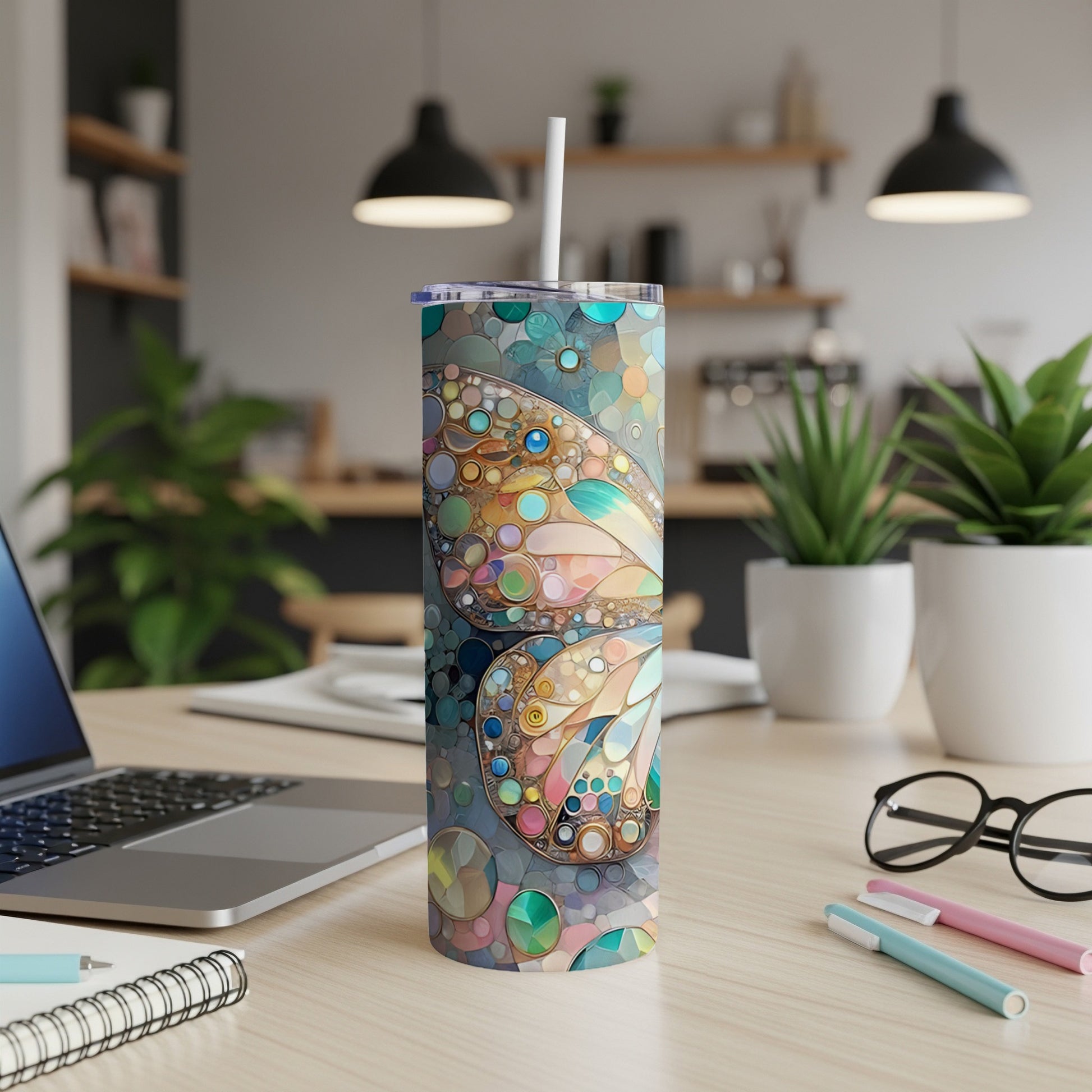 Abstract butterfly design on a skinny tumbler with a straw.