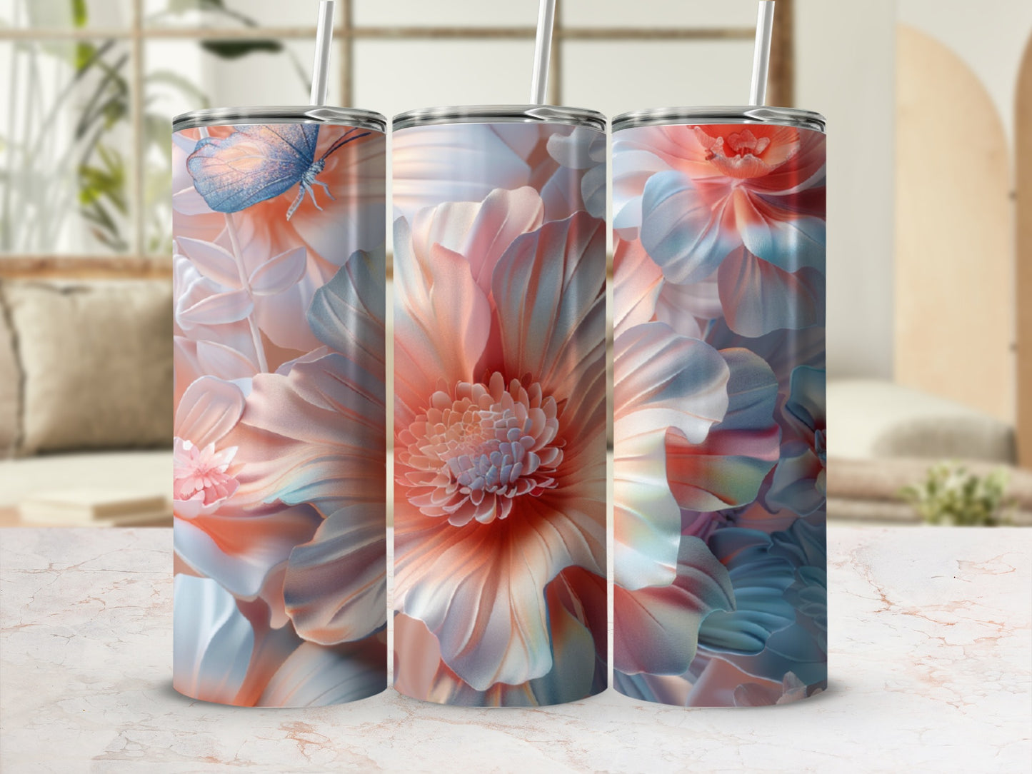 Three tumblers with floral and butterfly designs on a marble surface.