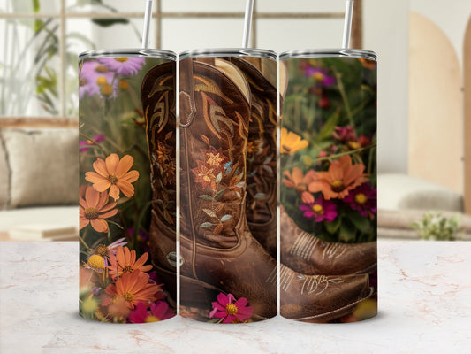 Brown cowboy boots with floral embroidery, set against a blurred garden background.
