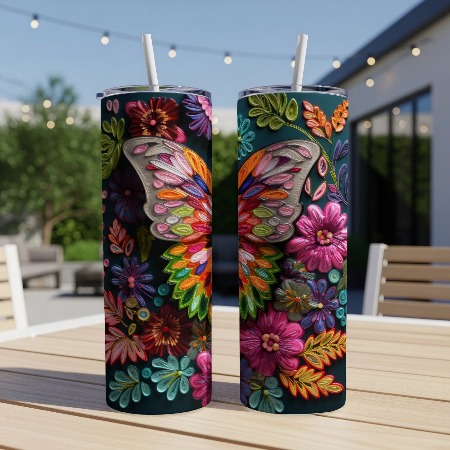 Two tall tumblers with colorful butterfly and floral designs on a table.