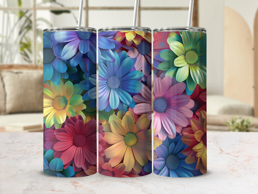 Three tumblers with colorful floral patterns sit on a table.