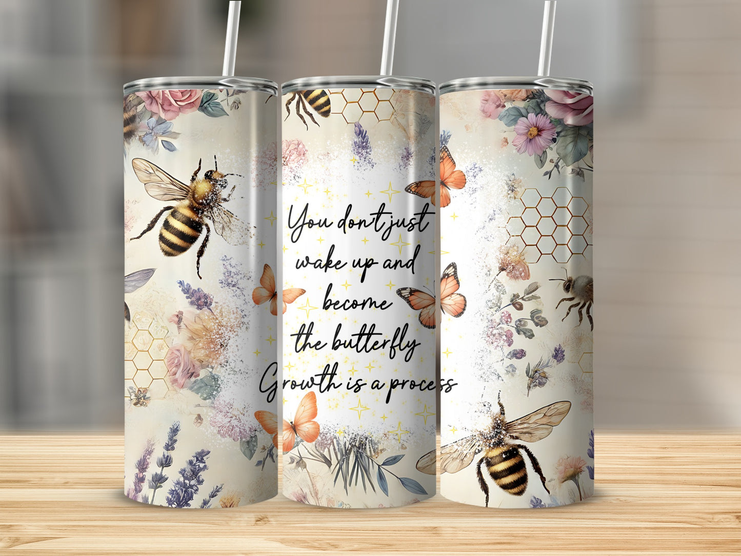 Floral tumbler with bees, butterflies, and inspirational text.