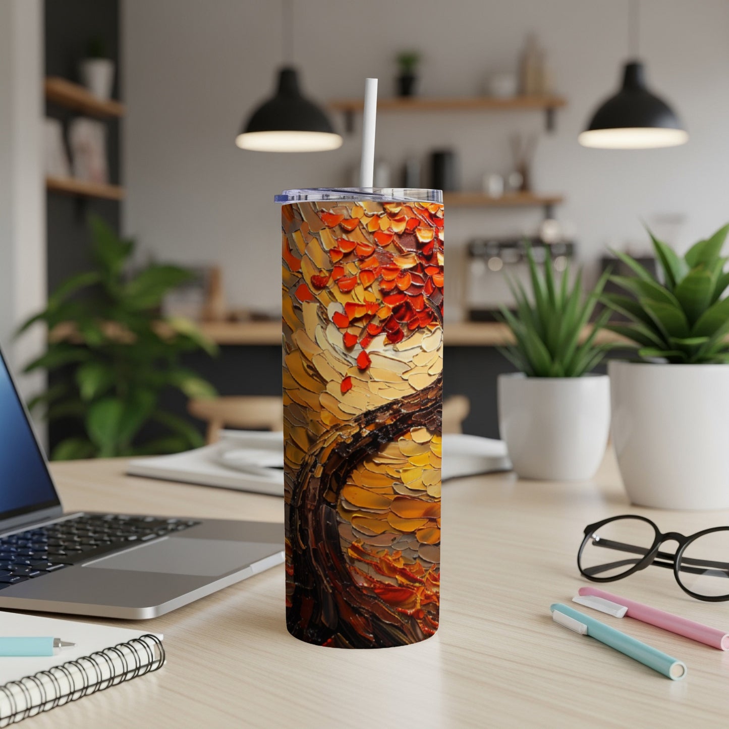 Abstract textured painting of a tree with red and orange leaves on a tumbler.