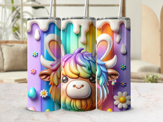 Colorful Highland cow tumbler with rainbow and floral accents.