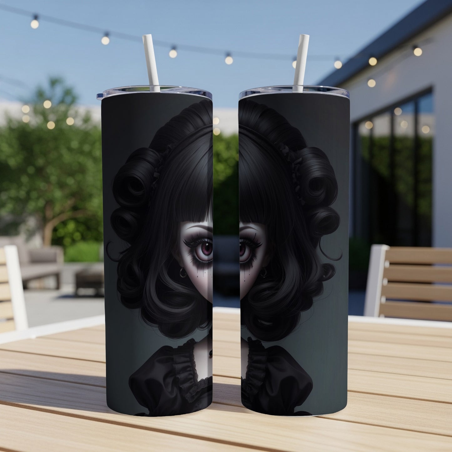 Gothic doll portrait on two tumblers with straws, outdoors on a table.