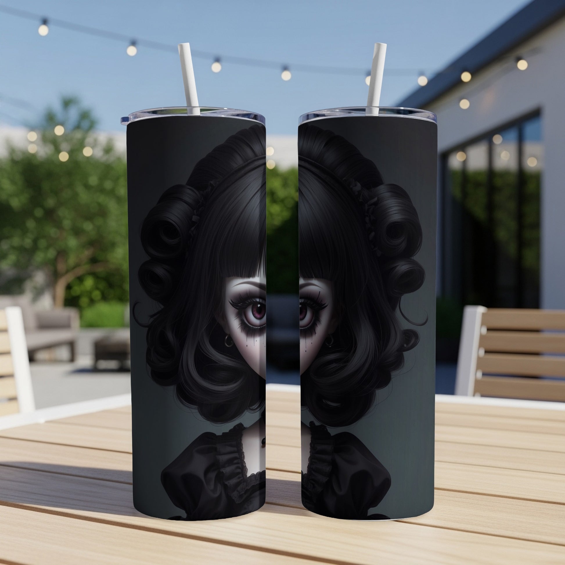 Gothic doll portrait on two tumblers with straws, outdoors on a table.