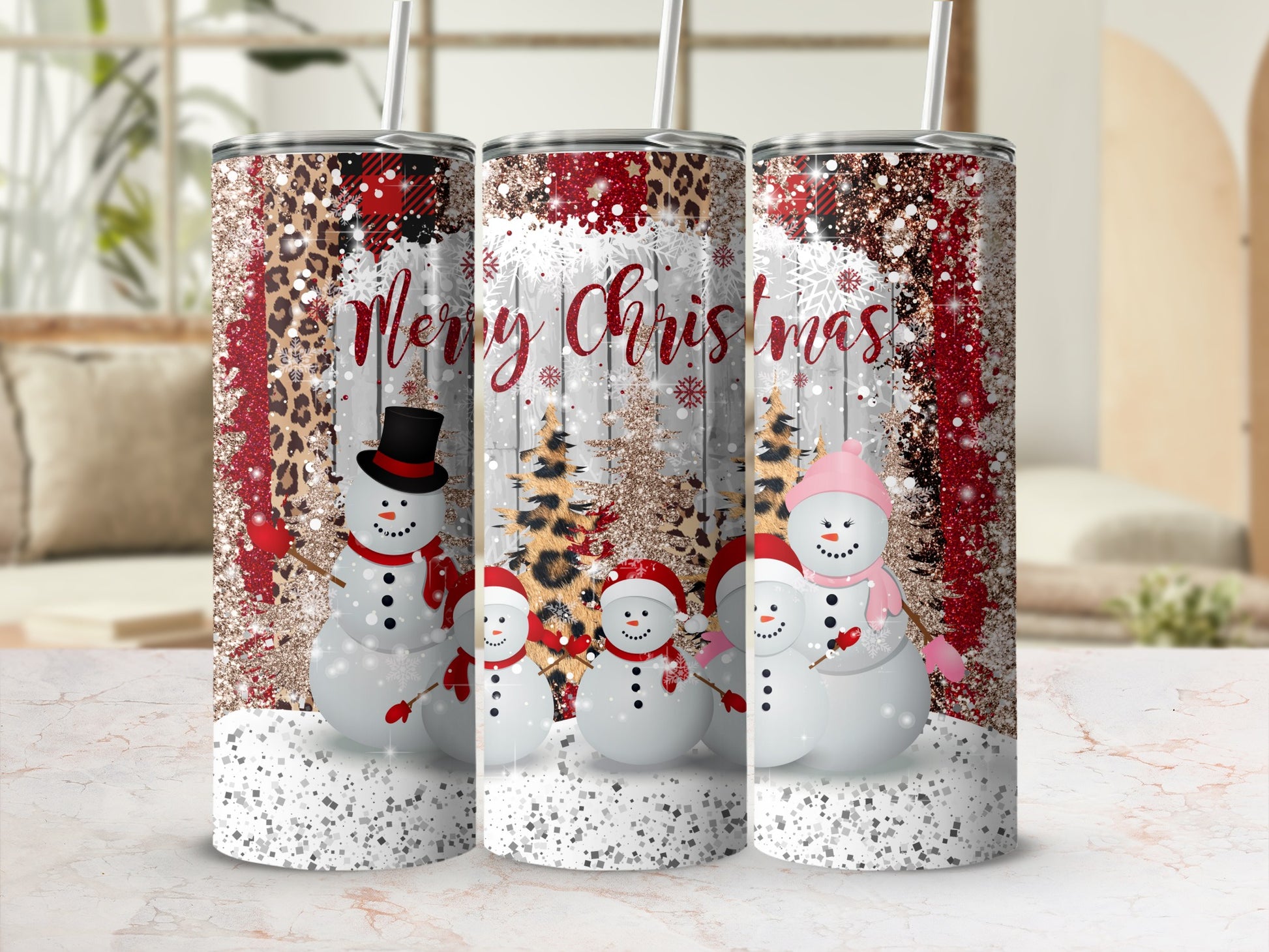 Three tumblers with snowmen, Christmas trees, and leopard print design.