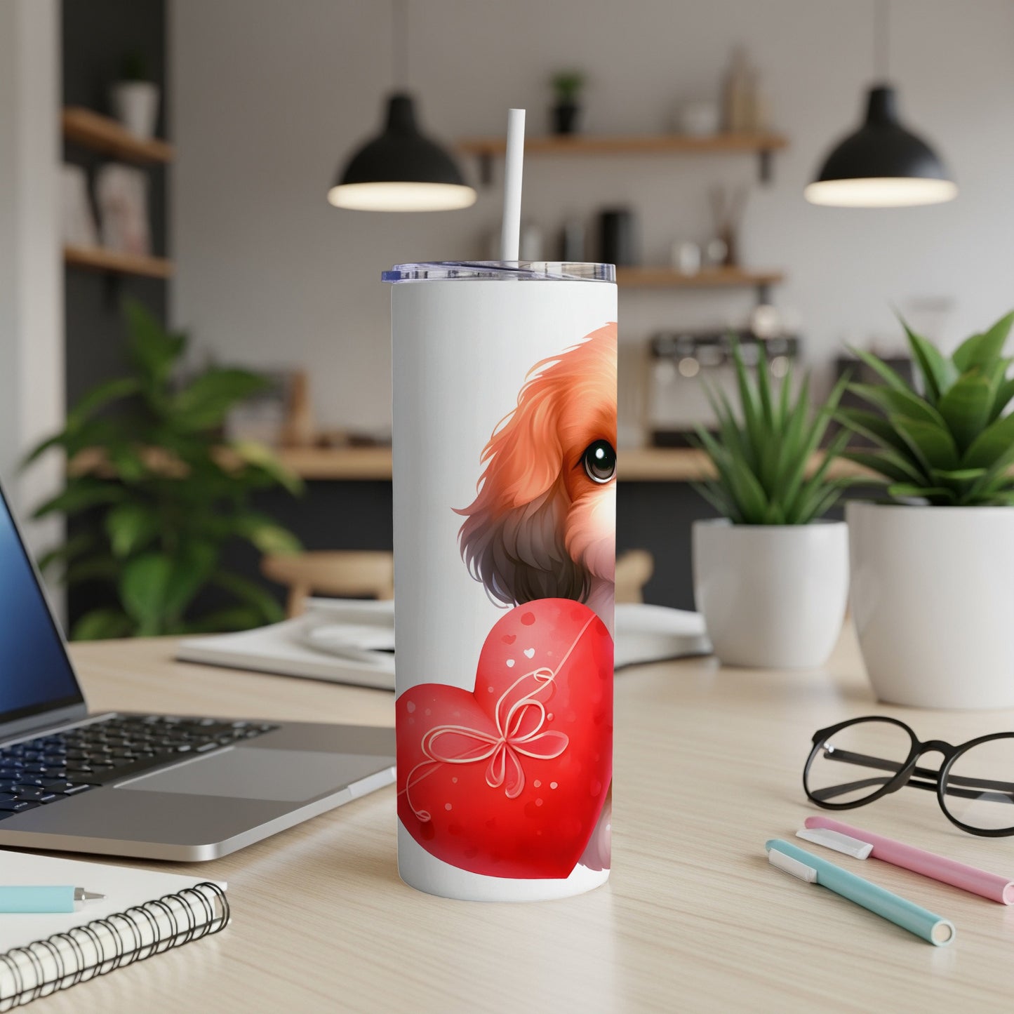 White tumbler with a cute dog holding a red heart and a straw.