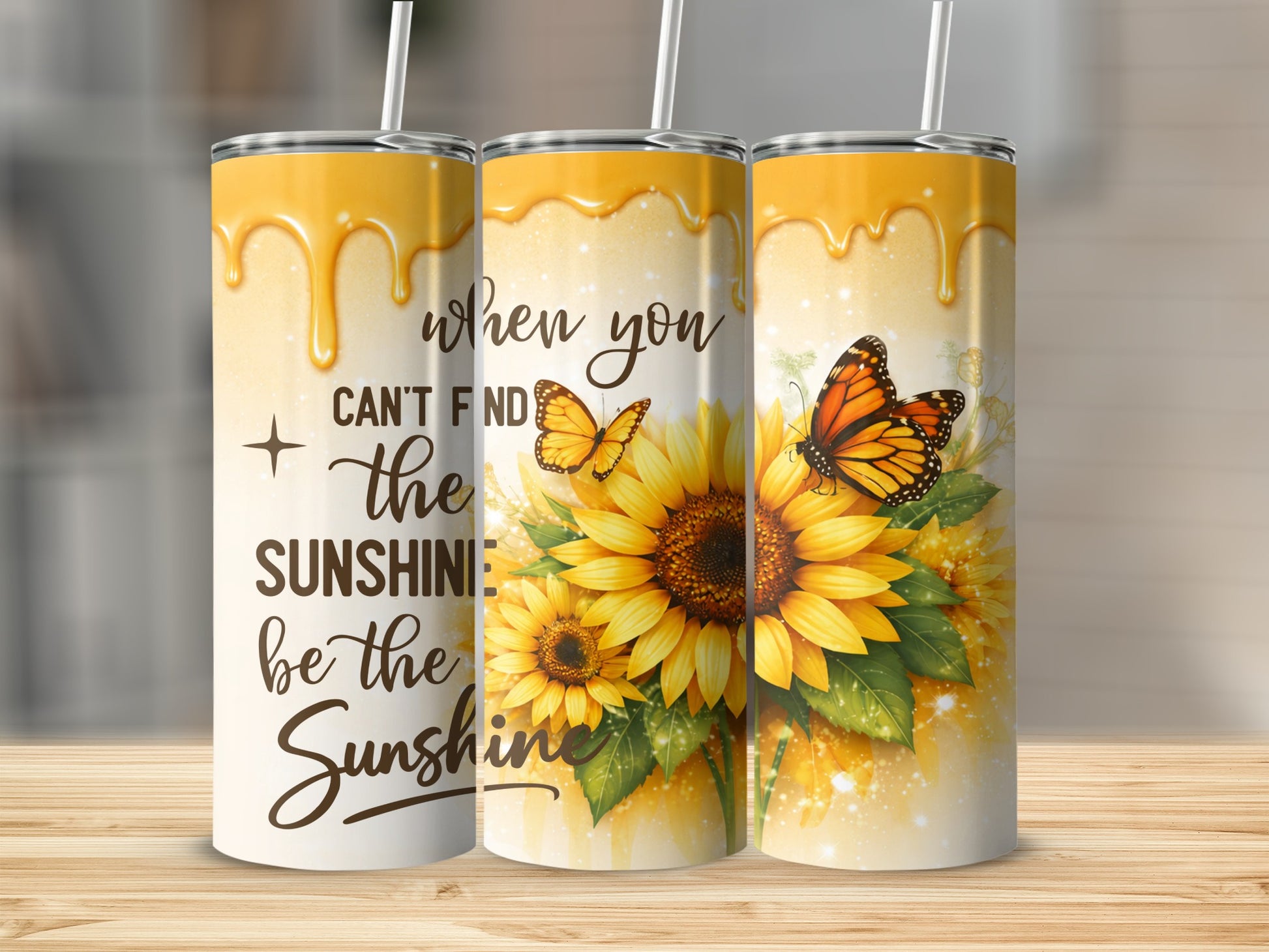 Three tumblers with sunflowers and butterflies, featuring "when you can't find the sunshine be the sunshine".