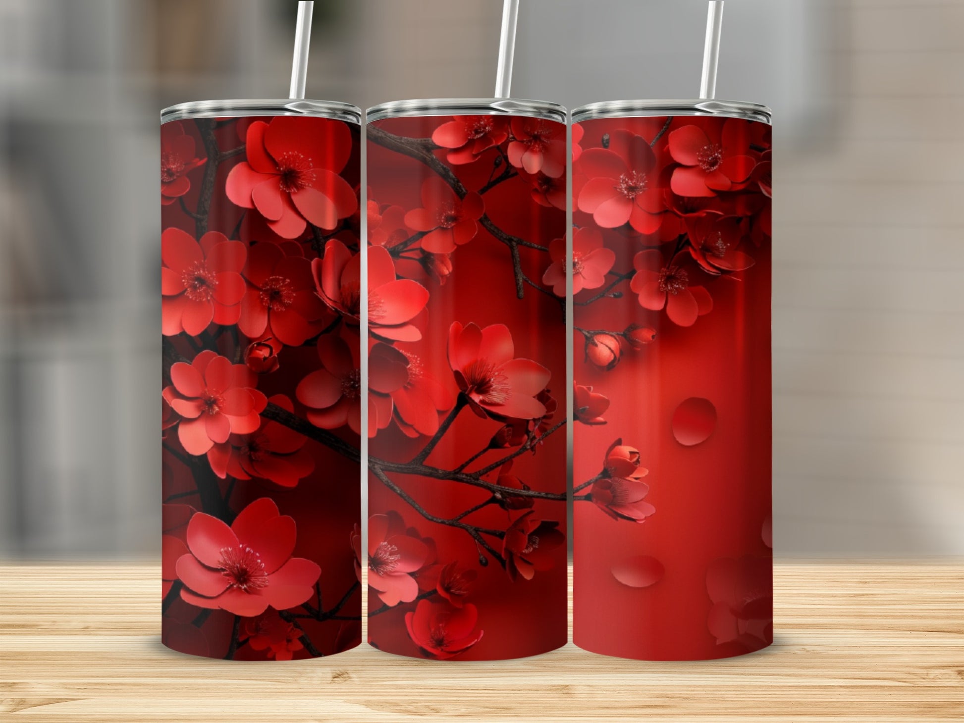 Three red tumblers with a floral cherry blossom pattern.