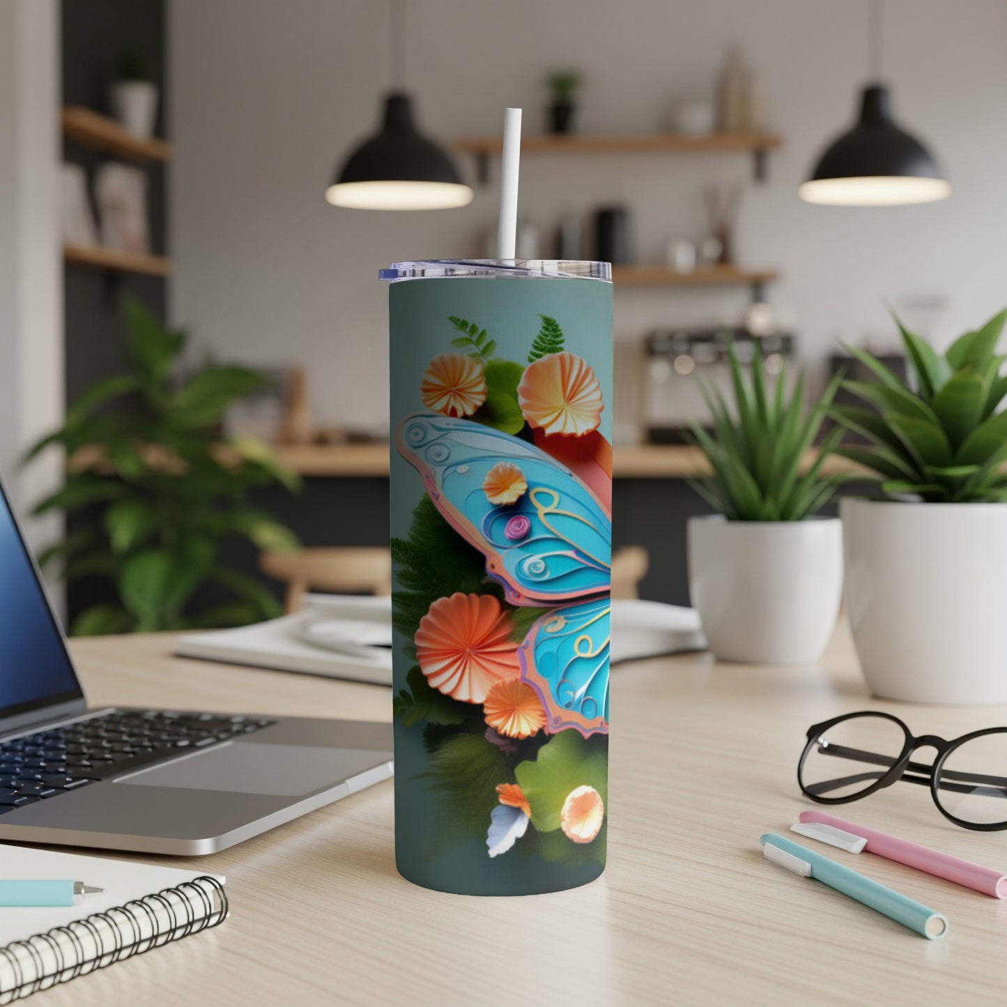 Tall tumbler with blue butterfly and floral design.