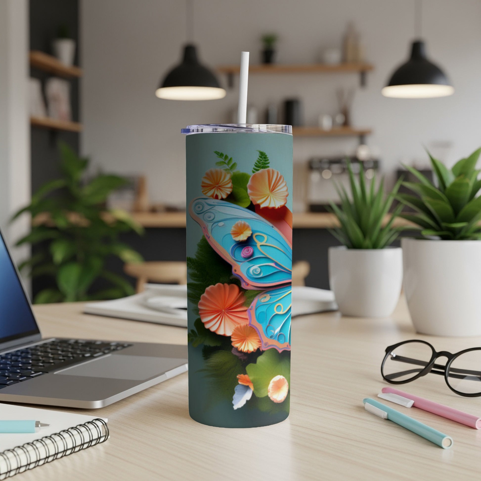 Tall tumbler with blue butterfly and floral design.
