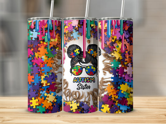 Tumbler with colorful puzzle pieces and "Autism Sister" text.
