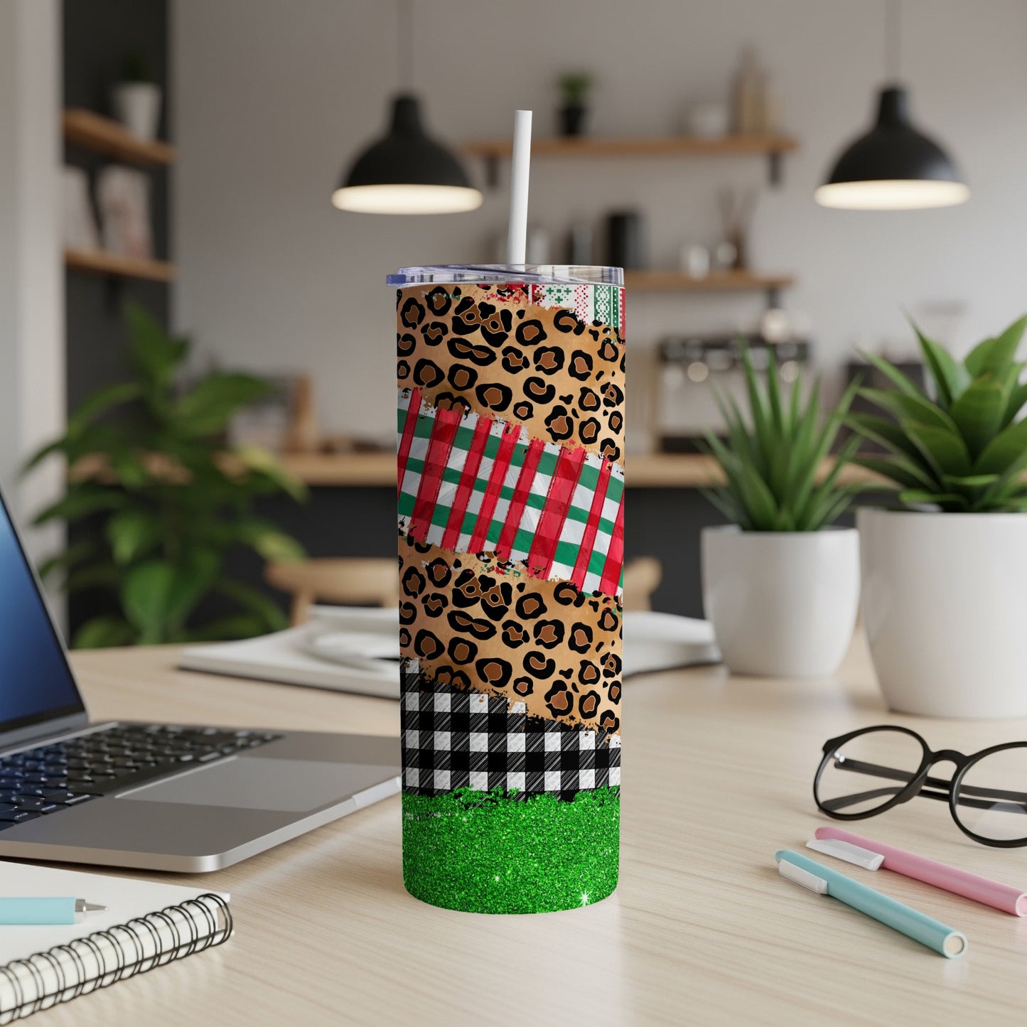 Christmas tumbler with plaid, leopard, and buffalo check patterns, and green glitter.