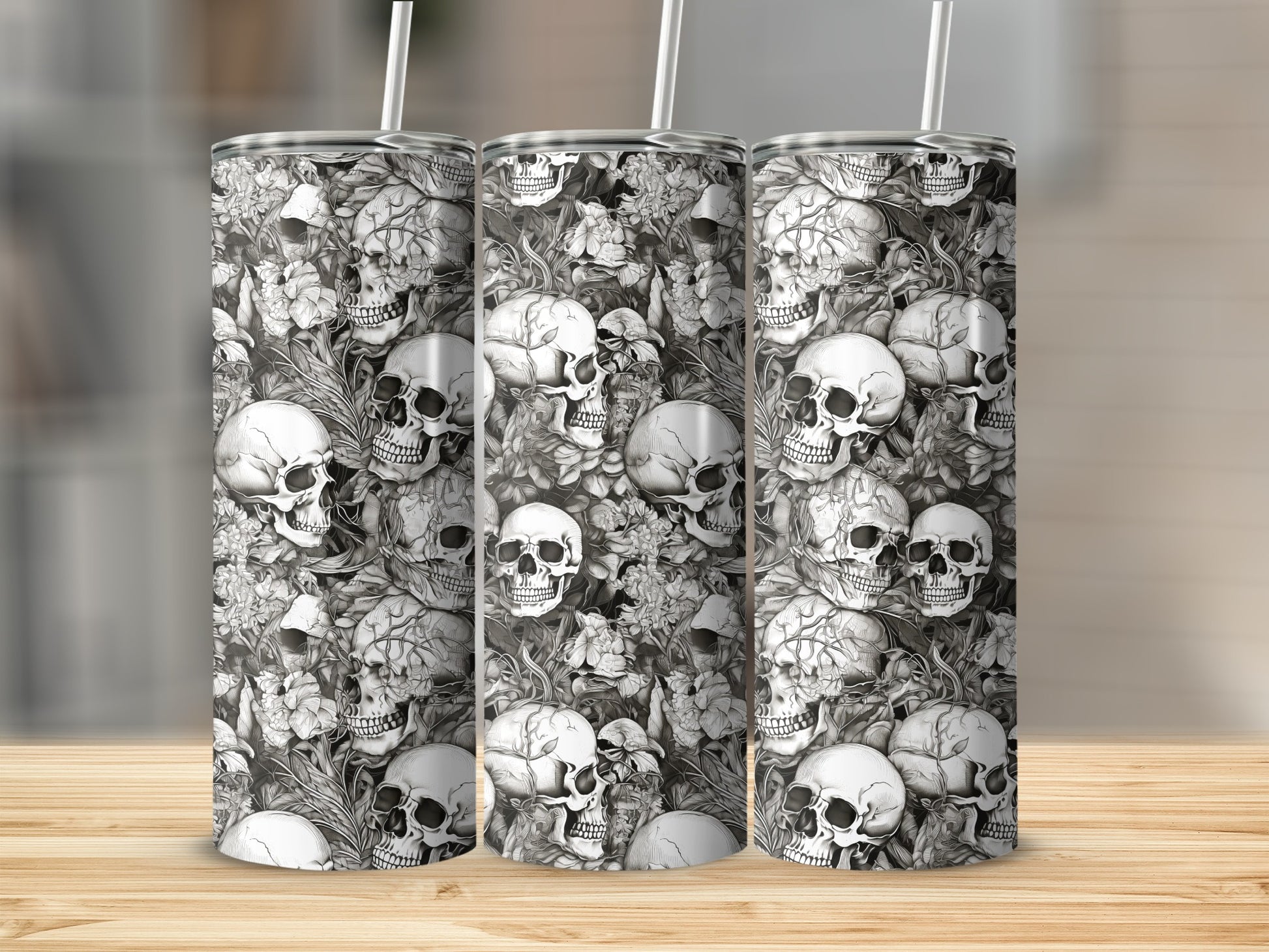 Three tumblers with a black and white skull and floral pattern.